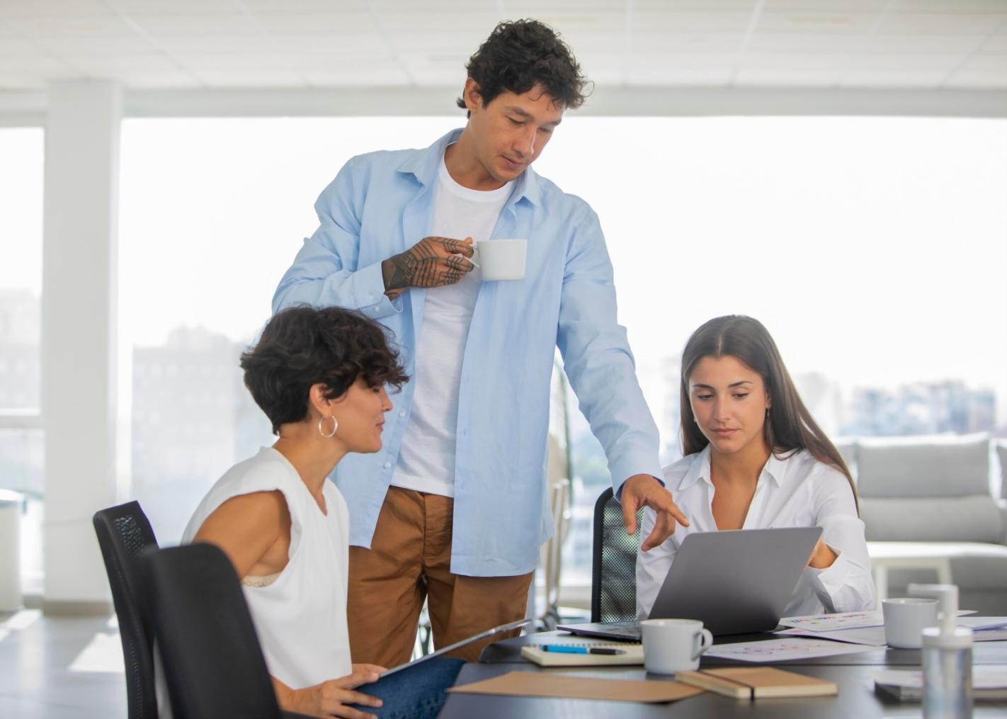 Modern office environment with financial professionals collaborating on market analysis